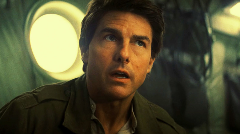Tom Cruise as Nick Morton looks up as he sits on a plane in The Mummy