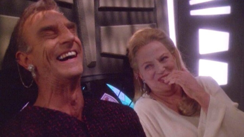 Marc Alaimo as Gul Dukat in Bajoran form and Louise Fletcher as Kai Winn, laughing together, on Star Trek: Deep Space Nine
