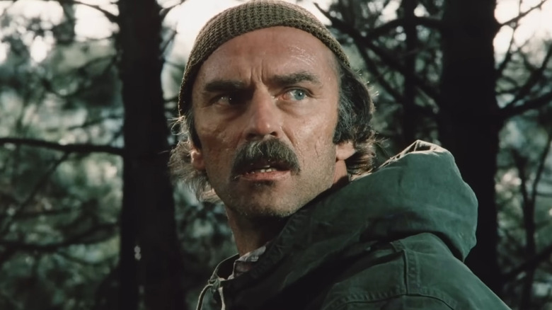 Marc Alaimo as Luke in Grizzly II: Revenge, looking concerned in a forest