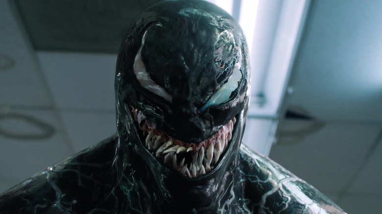 Venom grinning inside a convenience store in Venom (2018)