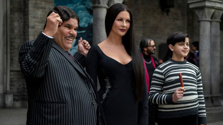 Gomez, Morticia, and Pugsley smiling in Wednesday