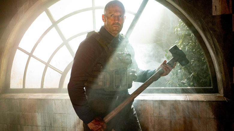 Jason Statham as Levon Cade holding a mallet and looking for his next target in A Working Man