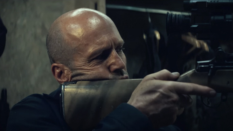 Statham's Levon holding a rifle in A Working Man