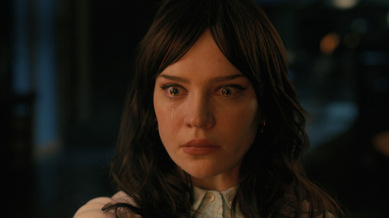 Companion Iris staring blankly at her own arm burning