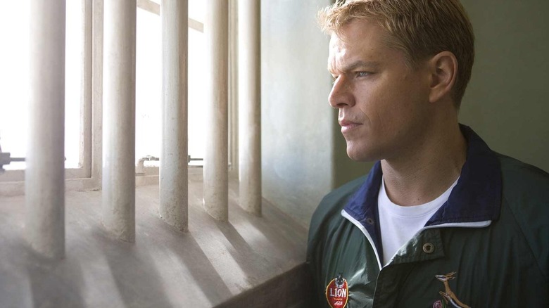 Matt Damon peers out of a jail window as Francois Pienaar in Invictus