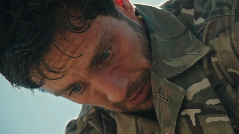 Aaron Taylor-Johnson's Major Will Tranter is seen looking worried from a low angle in Fuze