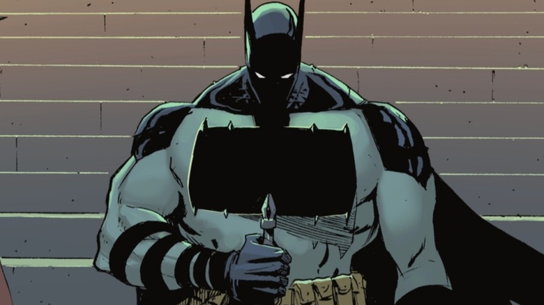 Batman holding a battle axe in front of his chest bat symbol in Absolute Batman #1