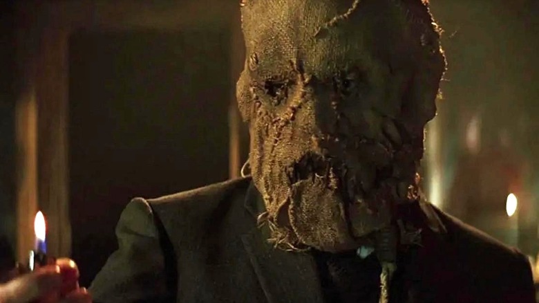 Scarecrow holding a lighter in Batman Begins