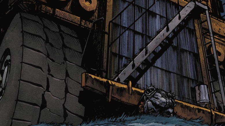 Absolute Batman Annual #1 - Batman crunched in a fetal position in front of a huge dump truck