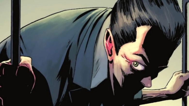 Absolute Batman #1 - The Joker in human form standing hunched in shadow