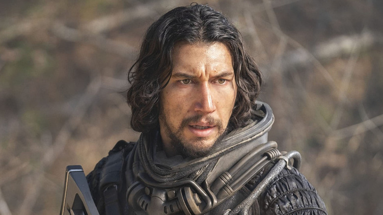 Adam Driver wearing futuristic black space suit in 65