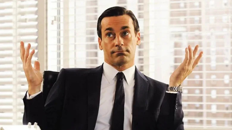 Mad Men, Jon Hamm as Don Draper, shrugging in his office with his hands in the air