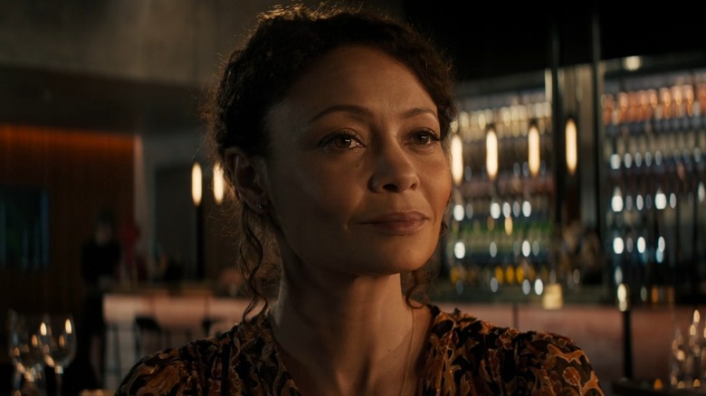 Celia (Thandiwe Newton) smiles pleasantly at a restaurant, from All The Old Knives