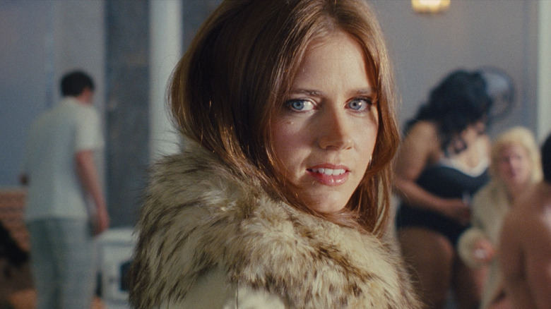 Amy Adams as Sydney Prosser wearing a fur coat in American Hustle