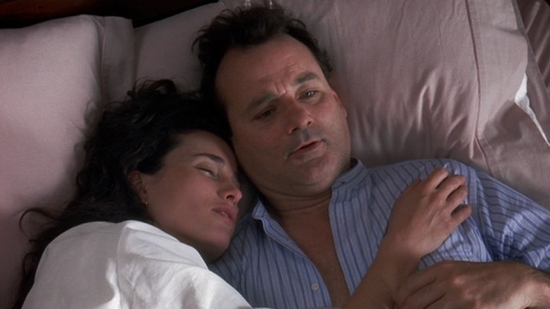 Andie MacDowell and Bill Murray as Rita and Phil in bed in Groundhog Day