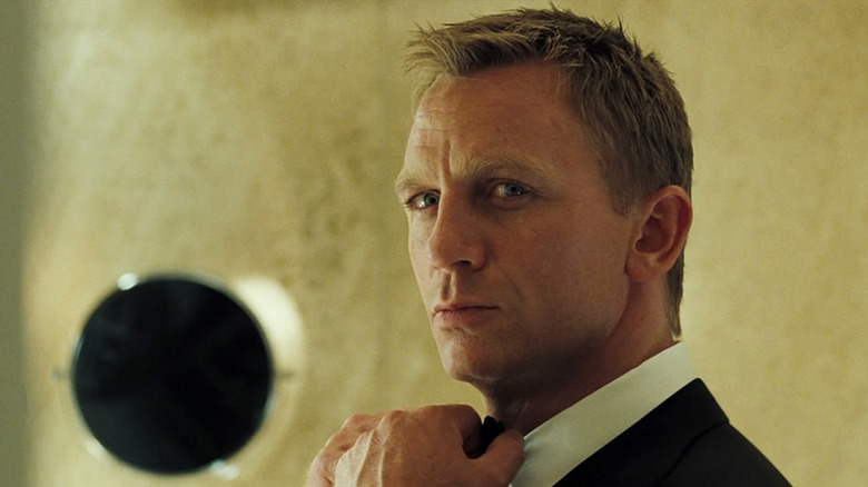 Daniel Craig as James Bond adjusting his tie in Casino Royale