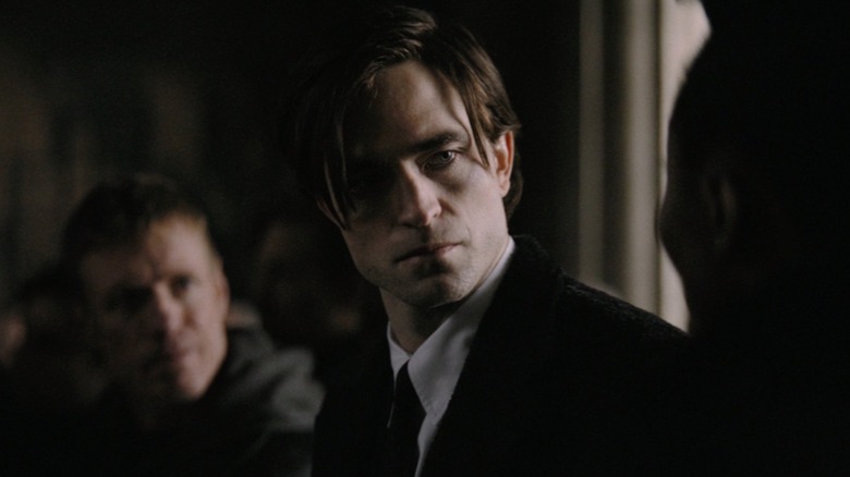 Robert Pattinson as Bruce Wayne scowling in The Batman
