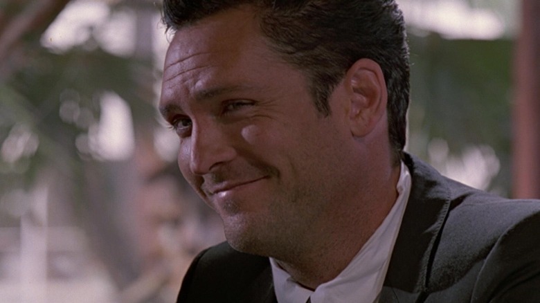 Mr. Blonde (Michael Madsen) smirks in Reservoir Dogs