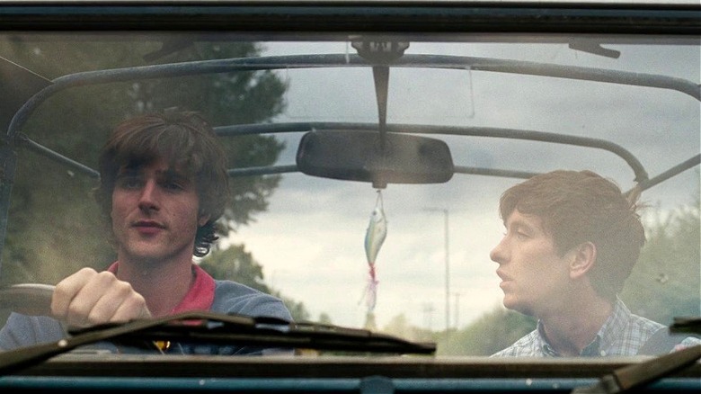 Jacob Elordi as Felix and Barry Keoghan as Oliver driving in a car in Saltburn