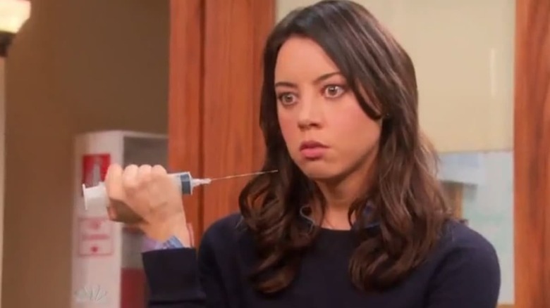 April holding syringe menacingly 