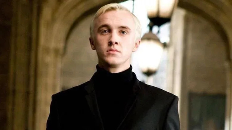 Draco Malfoy standing in black suit