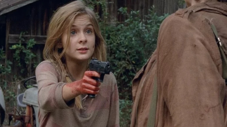 Lizzie pointing gun at someone