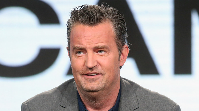 Matthew Perry in grey suit