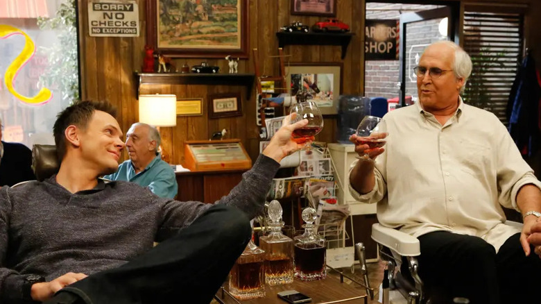 Joel McHale as Jeff Winger and Chevy Chase as Pierce Hawthorne having friendly drinks on Community.