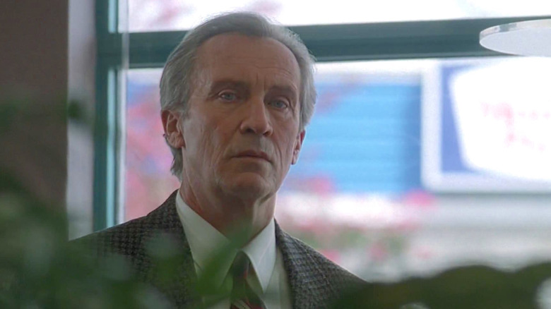 Roy Thinnes as Jeremiah Smith on an episode of The X-Files. He wears a prison jumpsuit and looks stern in a darkened space.
