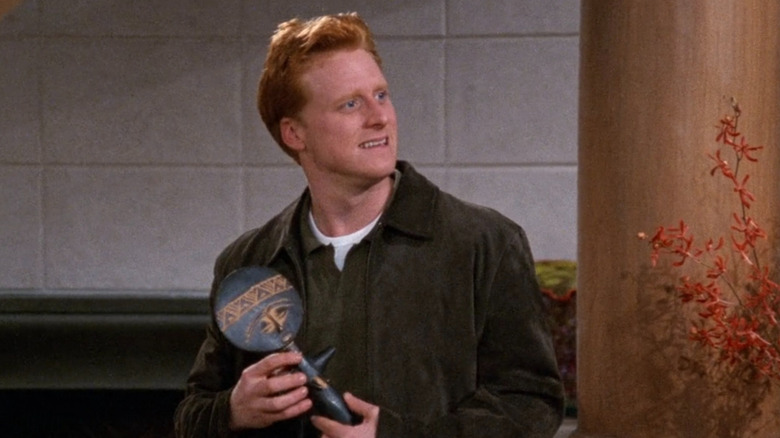 Alan Tudyk as the young KACL owner Todd Preston holding a fertility idol in Frasier