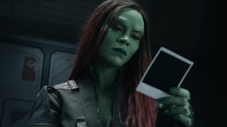 Gamora gazing into a polaroid