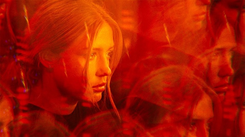 Adèle Exarchopoulos in a prism lens lit in red from the film the five devils