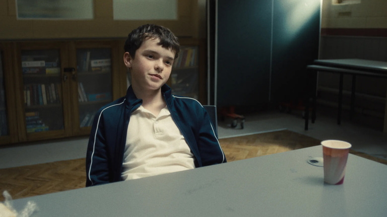 Owen Cooper as Jamie Miller looking cocky during a psychological review in Adolescence