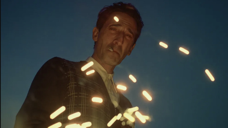 Adrien Brody as Laszlo Toth, who smokes a cigarette in the film 