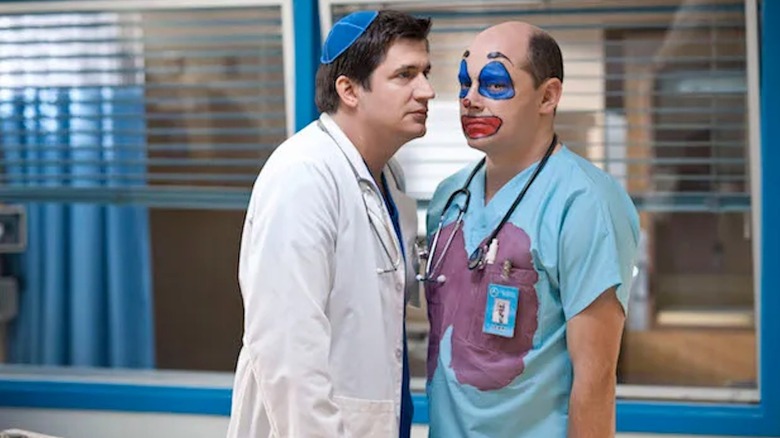 Ken Moreno as Dr. Glenn Richie gets in the clown-painted face of Rob Corddry as Dr. Blake Downs in Children's Hospital