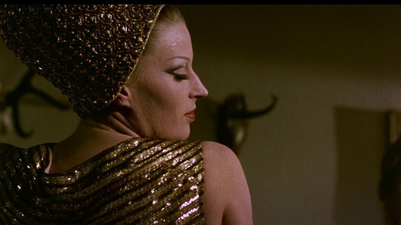 Silvana Mangano dancing in a golden outfit in The Witches
