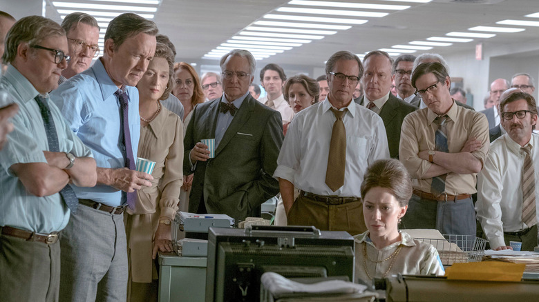 The staff of the Washington Post all gathering around a TV set with concern in The Post
