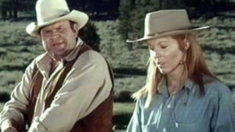Hoss riding next to Mary Burns on Bonanza