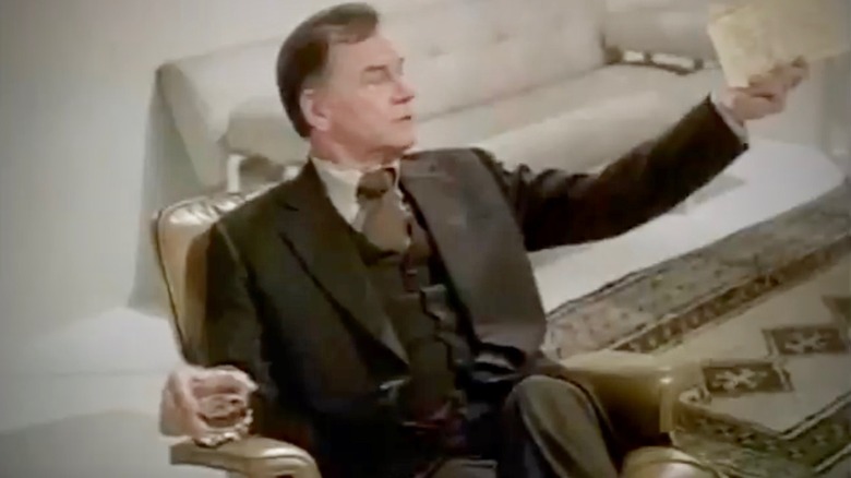 Dr. 'Ham' Hamilton sitting with a drink in the 1977 TV movie Spectre