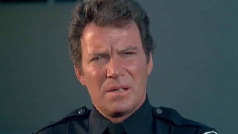 Thomas Jefferson Hooker (William Shatner) looks out over a crime scene in T.J. Hooker