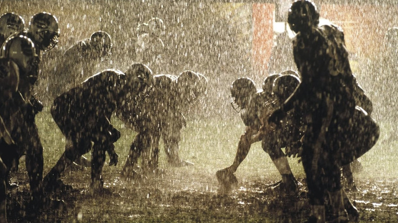 Two football teams line up against each other in the rain in Any Given Sunday