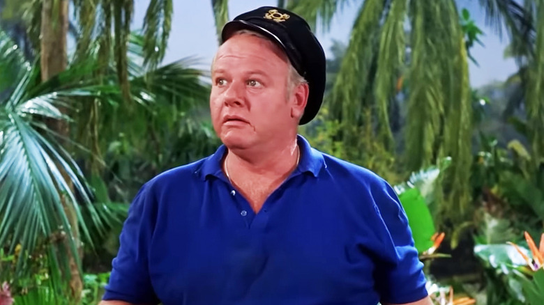 Alan Hale Jr's Captain Jonas Grumby stands on the island looking off to his right in Gilligan's Island
