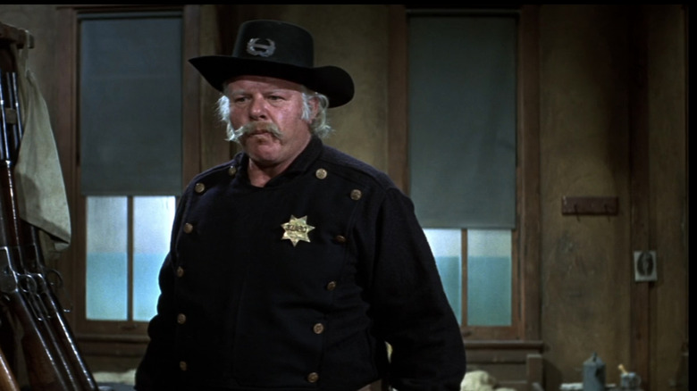 Alan Hale Jr's Tobaccy stands in an armory in There was a Crooked Man