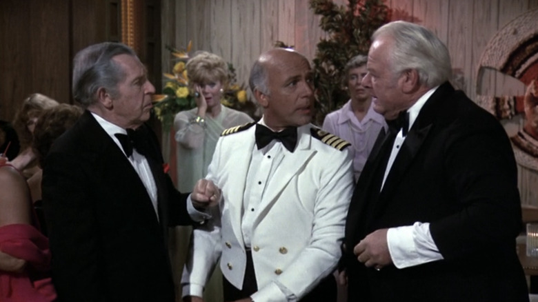 Alan Hale Jr.'s Jack McTigue stands opposite Milton Berle's Ed Taylor while  Gavin MacLeod's Captain Merrill Stubing tries to separate them in The Love Boat