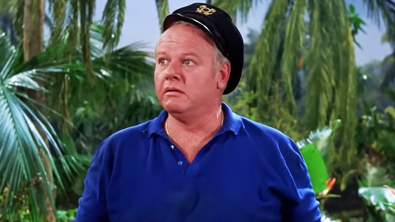 Alan Hale Jr's Captain Jonas Grumby looks confused as he stands on the island in Gilligan's Island