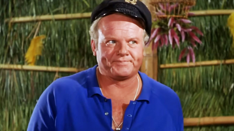 Alan Hale Jr.'s Captain Jonas Grumby looks annoyed as he stands in a shack in Gilligan's Island