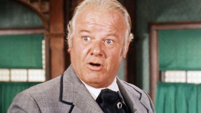 Alan Hale Jr's Bull Bannock is seen in closeup as he stands in a saloon in Gunsmoke