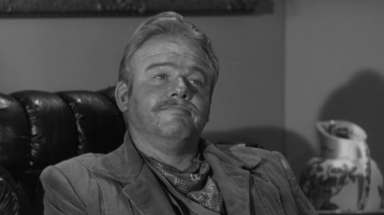 Alan Hale Jr.'s William Poe/Shawnee Bill sits in a chair looking up in Wanted Dead or Alive