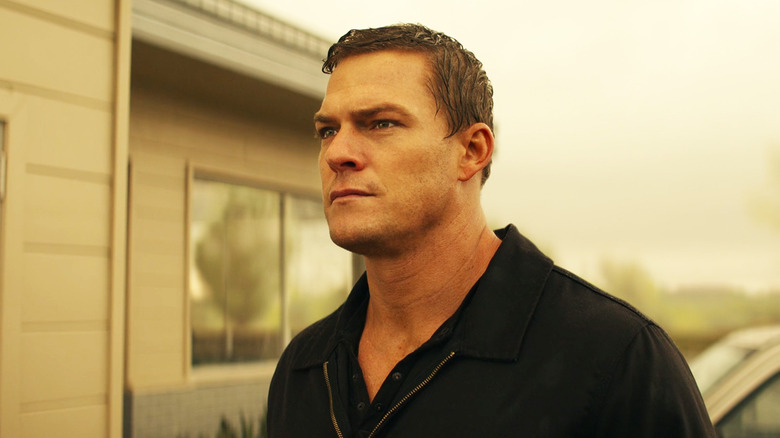 Alan Richson while Jack Rich stands abroad, he looks intense in Reacher