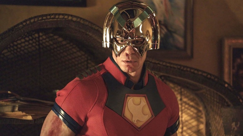 Chris stands shocked and appalled in a living room in Peacemaker